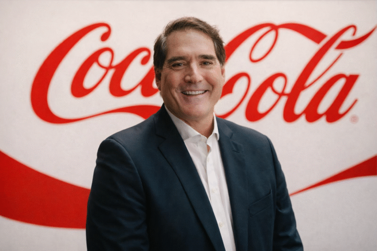 Hombre sonriente frente al logo Coca-Cola